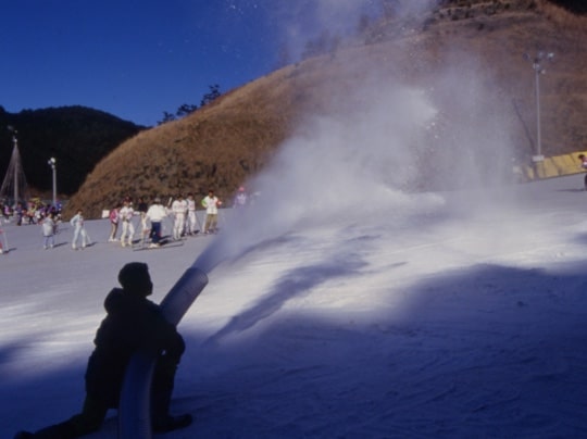 person using snow machine with a hose